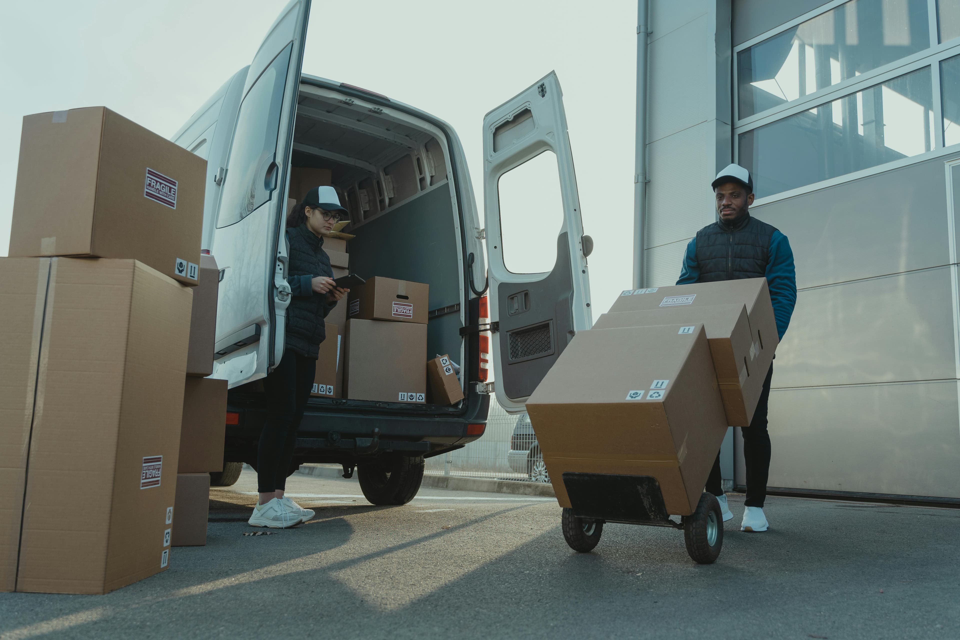 Logistics team loading packages into a delivery van